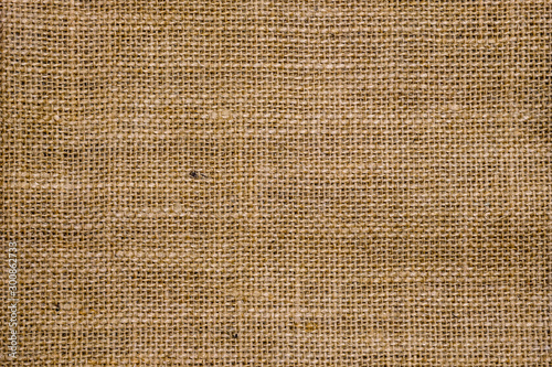 Rough hessian background with flecks of varying colors of beige and brown. with copy space. office desk concept, Hessian sackcloth burlap woven texture background.