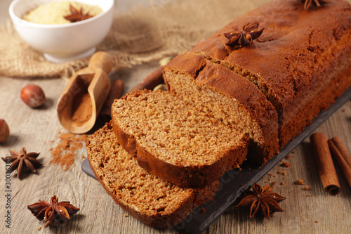 gingerbread cake with spices on wood background photo