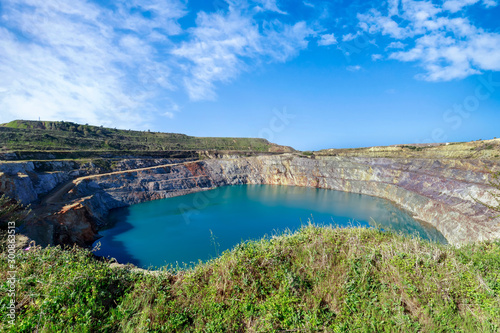 Amazing view of Open Pit Mining on blue sky.