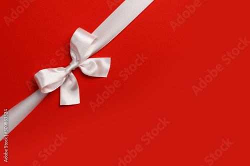 White gift bow on red