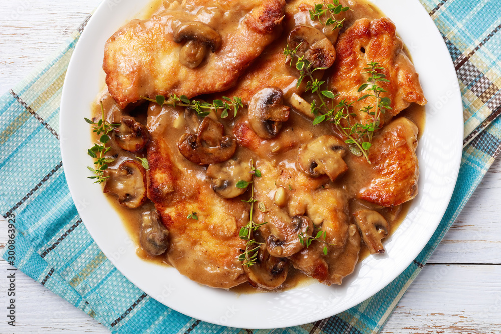 rustic style of Chicken Marsala on a plate rustic style of Chicken Marsala on a plate