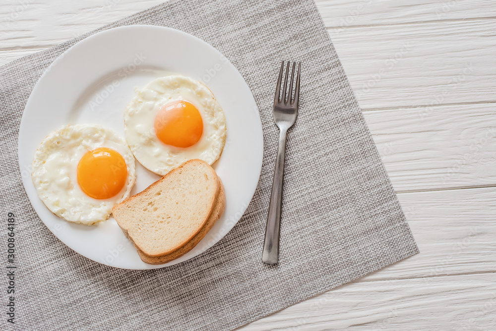 Healthy breakfast with fried eggs on wooden table Healthy breakfast with fried eggs on wooden table