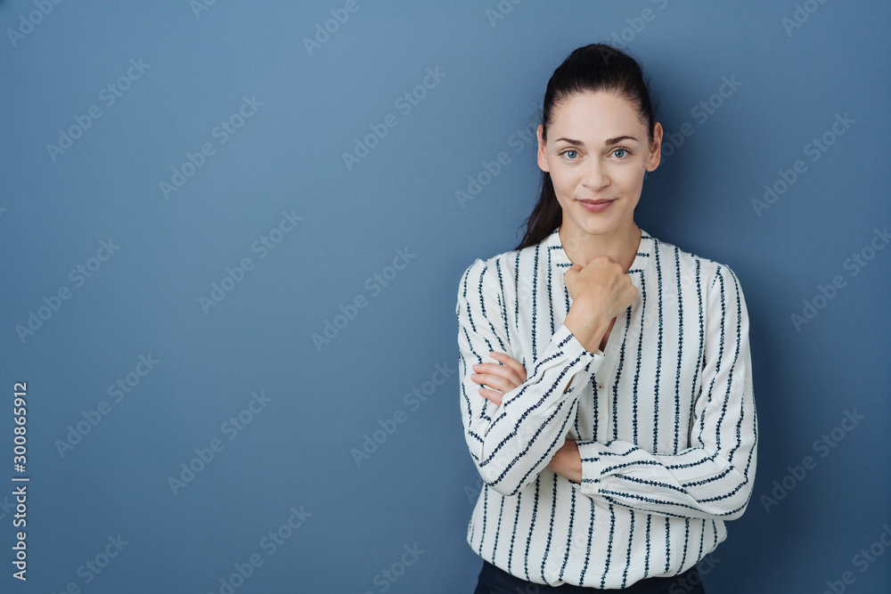 Thoughtful young woman smiling at the camera Thoughtful young woman smiling at the camera