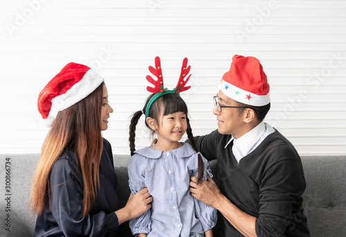 Family Asian mother and father with daughter celebration happy christmas together in livingroom at home.