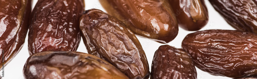 close up view of tasty dried dates isolated on white, panoramic shot