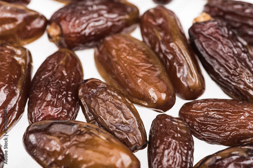 close up view of tasty dried dates isolated on white close up view of tasty dried dates isolated on white