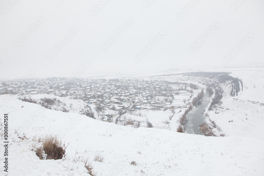 winter panorama with village on the valley 