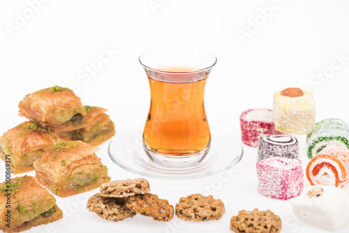 cup of tea near baklava, turkish delight and gozinaki isolated on white