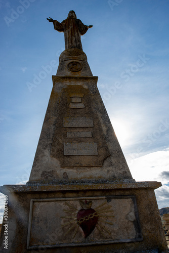 The statue with the Christ of Medinaceli under the blue sky