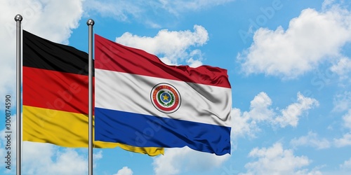 Germany and Paraguay flag waving in the wind against white cloudy blue sky together. Diplomacy concept, international relations.