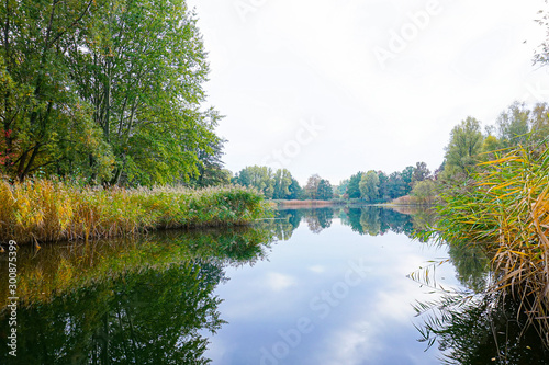 beautiful lakeside with trees and refelctions in autumn photo