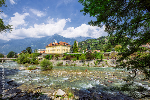 MERANO, ITALY - JULY 20, 2019 - Merano Winterpromenade along the torrente Passirio. Its most distinctive landmark is the Wandelhalle covered passageway photo