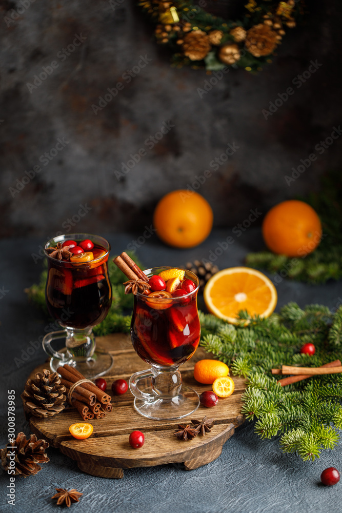 Christmas mulled red wine with spices, cranberry and fruits. Traditional Christmas hot drink. Christmas drink background