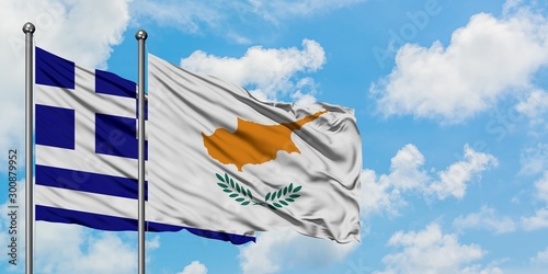 фотографія Greece and Cyprus flag waving in the wind against white cloudy blue sky together