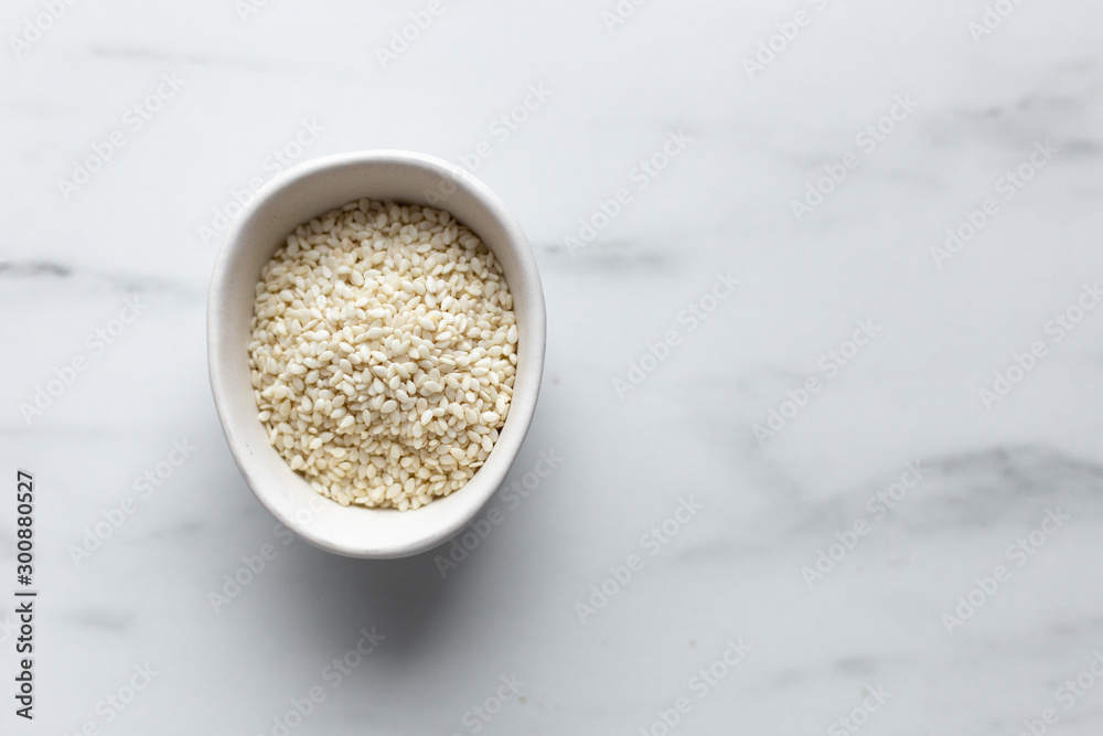 Sesame seeds on marble background with copy space Sesame seeds on marble background with copy space