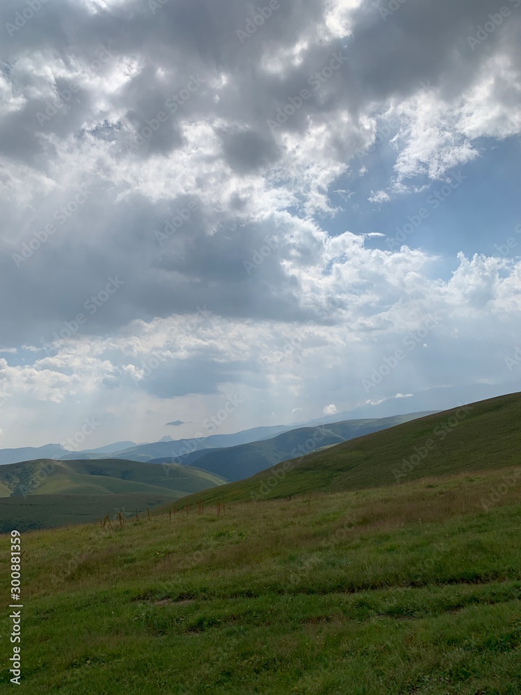 mountain landscape with fluffy clouds