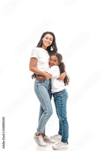 Fotografie, Obraz happy african american mother and daughter embracing and looking at camera on wh