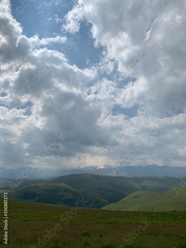 mountain landscape with fluffy clouds