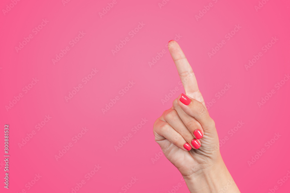 Closeup of isolated female hand counting from 0 to 5. Woman shows one finger. Manicured nails painted with beautiful modern pink gel polish. Math concept.