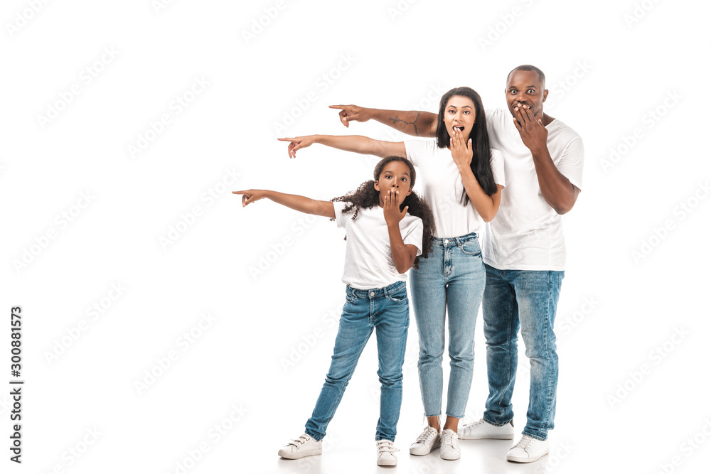 shocked african american parents pointing with fingers and covering mouths with hands on white background