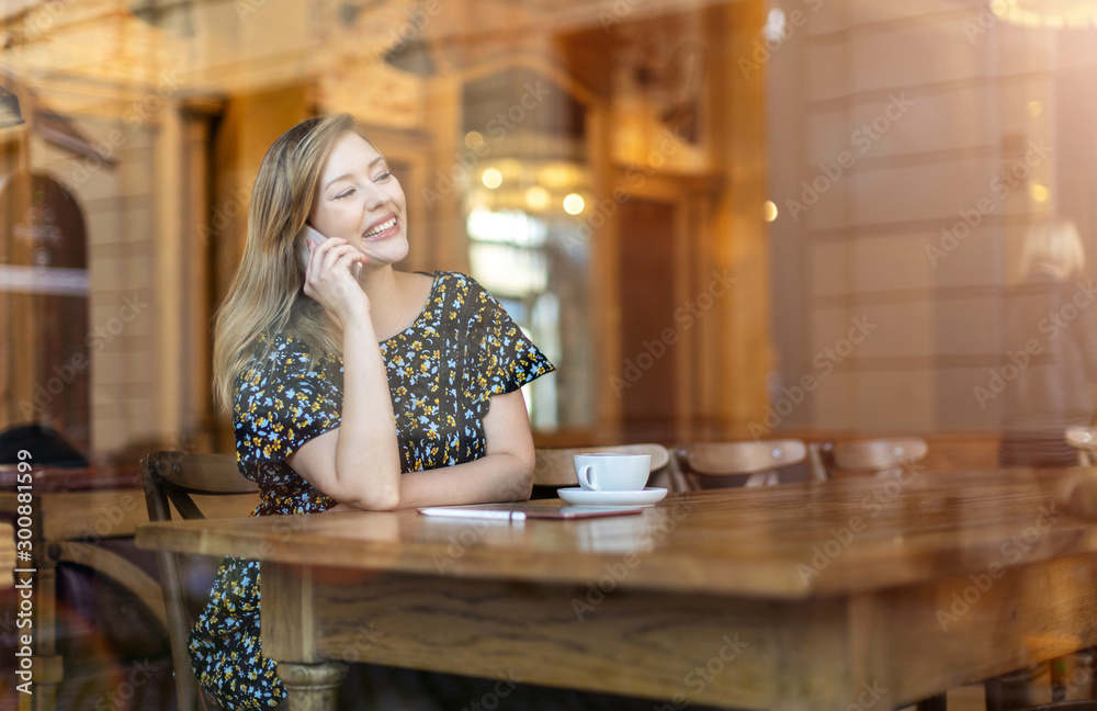 Beautiful young woman using smartphone at cafe Beautiful young woman using smartphone at cafe