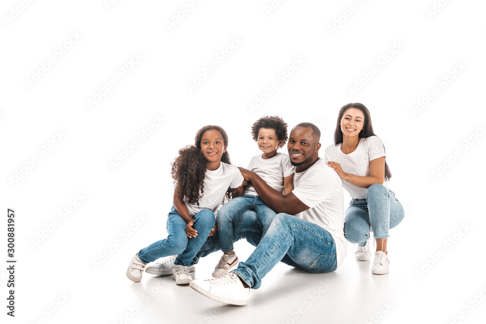 happy african american family smiling at camera while sitting on white background happy african american family smiling at camera while sitting on white background
