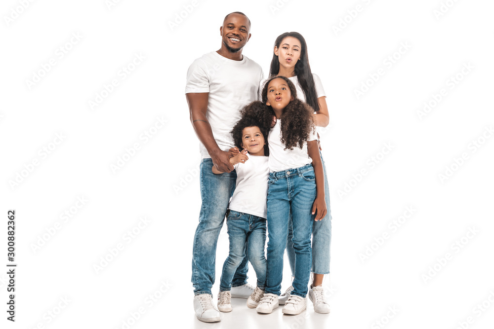 cheerful african american mother and daughter making duck faces while standing near father and son on white background cheerful african american mother and daughter making duck faces while standing near father and son on white background