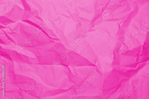 Crumpled recycle pink paper background - Pink paper crumpled texture - Pink paper wrinkled background. © Namfon