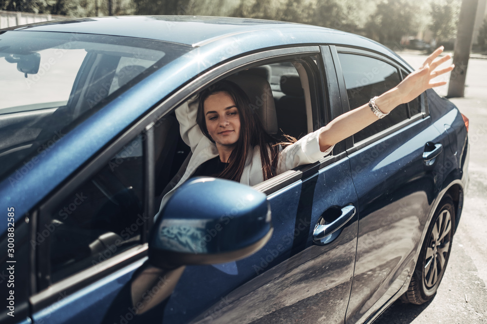 Fashion Stylish Driver Girl in White Suit Sitting in the Car