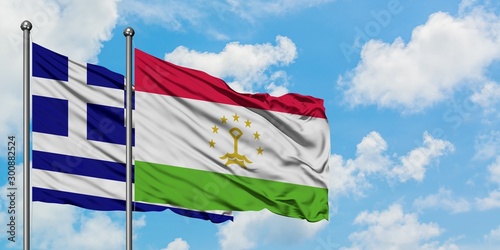 Greece and Tajikistan flag waving in the wind against white cloudy blue sky together. Diplomacy concept, international relations.
