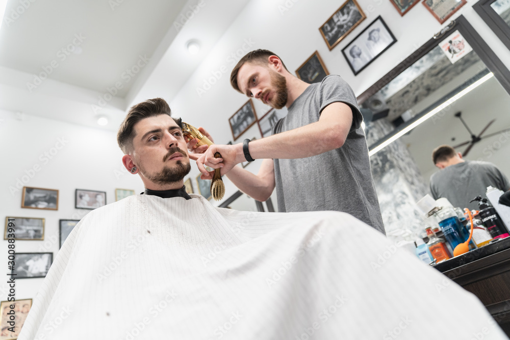 Haircut and beard haircut in barbershop. Man haircut