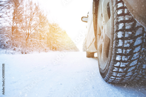 Car wheel with winter tire on snow road