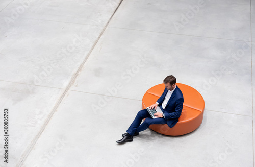 Businessman using laptop sitting alone top view, copy space background photo