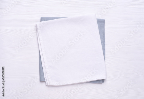 Napkins on white wooden table top. Mock up for design. Top view photo