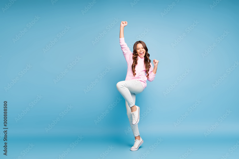 Fototapeta premium Full length body size turned photo of cheerful pink positive nice cute preteen rejoicing in having won jackpot and holidays started isolated pastel blue color background
