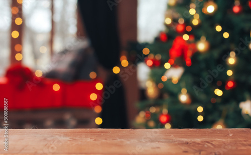 Christmas abstract background. Empty wooden table, horizontal surface in front of Xmas tree. New Year, light bokeh, celebration, holiday, party, copy space