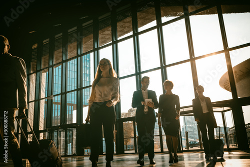 Group of business people walking in airport hall
