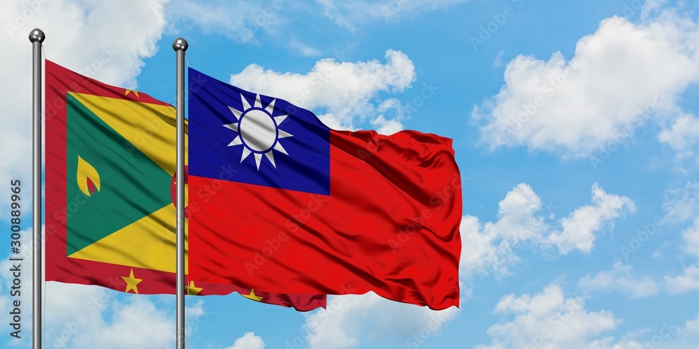 Grenada and Taiwan flag waving in the wind against white cloudy blue sky together. Diplomacy concept, international relations. Grenada and Taiwan flag waving in the wind against white cloudy blue sky together. Diplomacy concept, international relations.