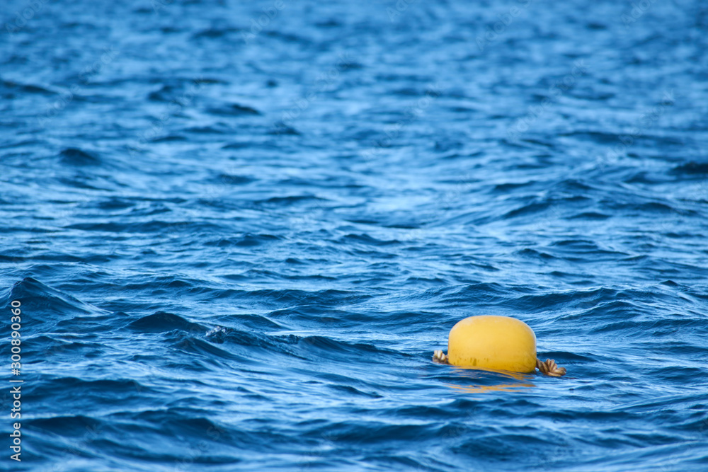 Yellow buoy on the sea waves background Yellow buoy on the sea waves background