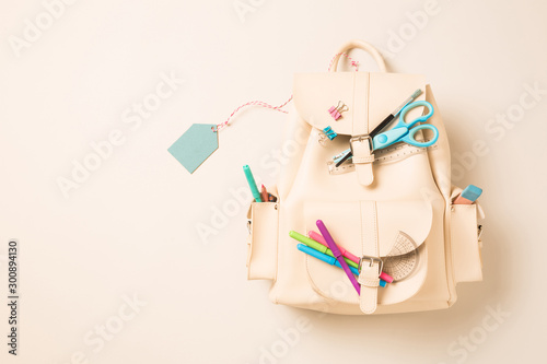 White backpack with school supplies and blank tag - education photo