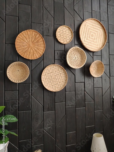 dark wall with decor. wicker plates. baskets on the wall.wicker plates on the wall