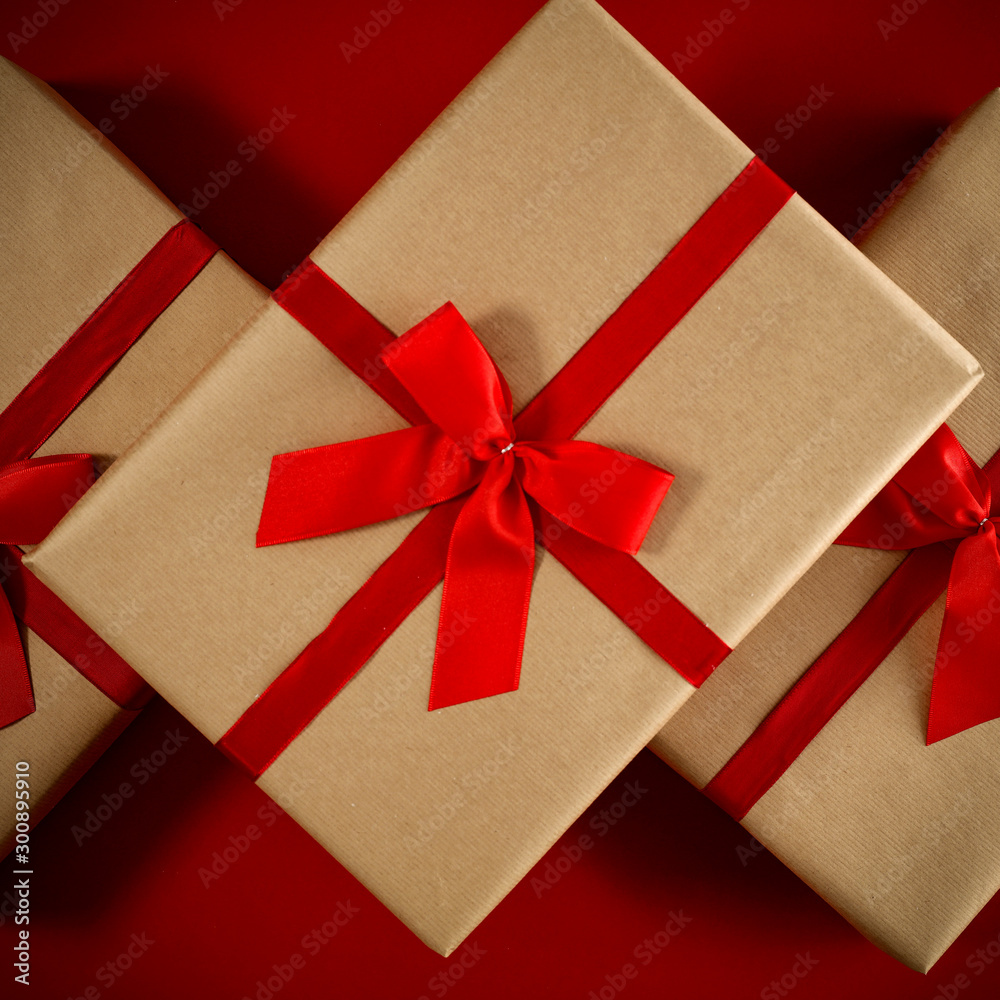Red flat lay background of christmas time. Free empty space for your product. Xmas gifts decoration and copy space. Cold winter december day and Santa Claus boxes. Top view, aerial photo. Red flat lay background of christmas time. Free empty space for your product. Xmas gifts decoration and copy space. Cold winter december day and Santa Claus boxes. Top view, aerial photo.
