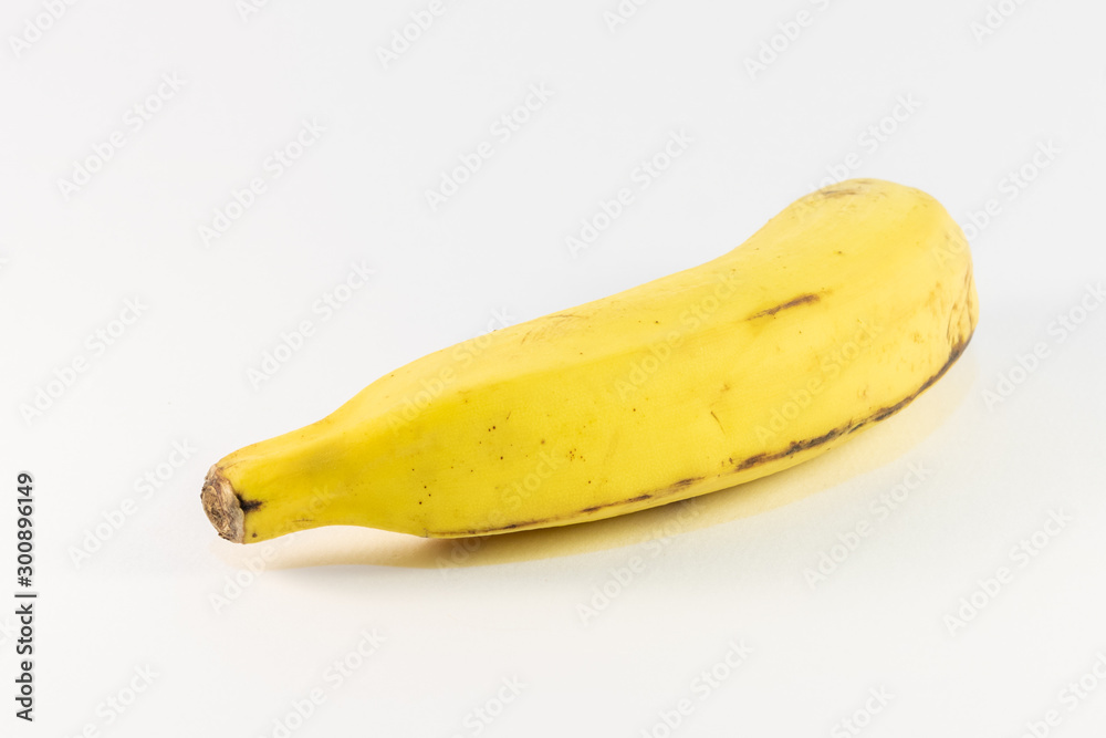 Single yellow banana in a white back ground