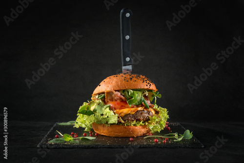 Beef burger on black background. For fast food restaurant design or fast food menu