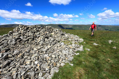 Walker, Summit cairn on Selside Fell, Mardale Common, Lake District National Park, Cumbria County, England, UK photo