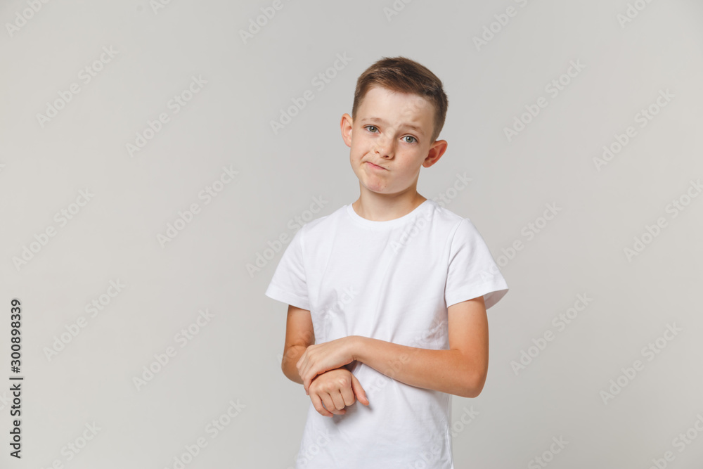 Portrait of upset boy standing with arms folded isolated over white background Portrait of upset boy standing with arms folded isolated over white background