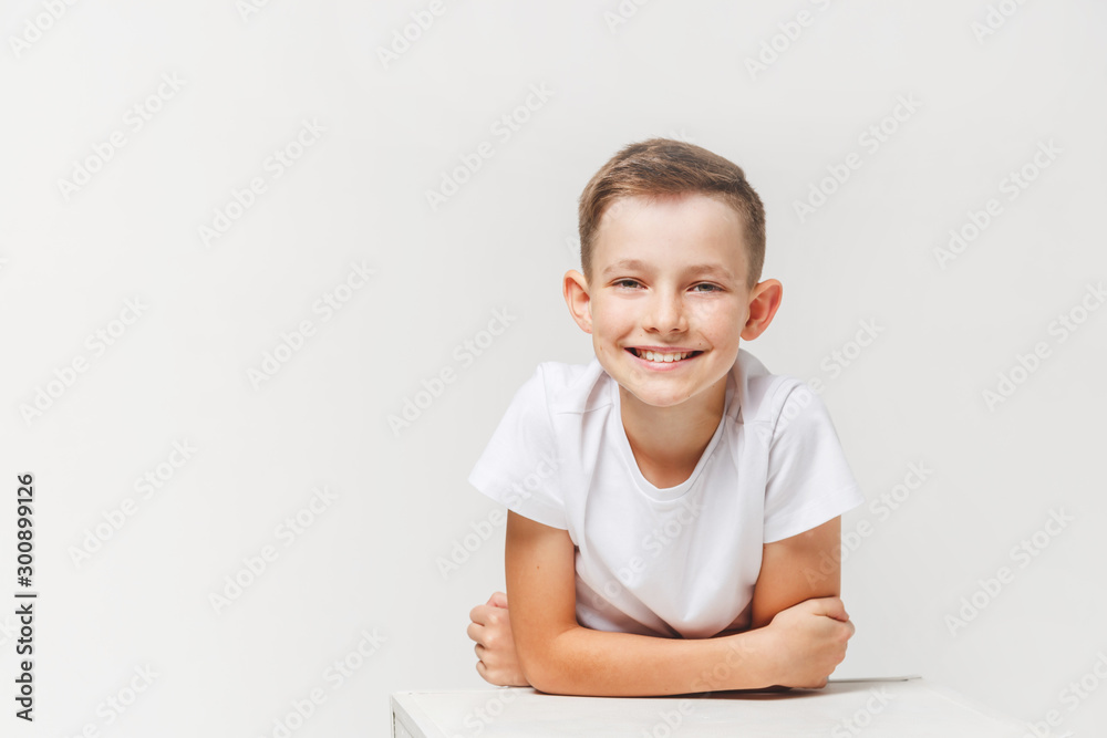 Close up portrait of young smiling cute teenager in white, isolated on white Close up portrait of young smiling cute teenager in white, isolated on white