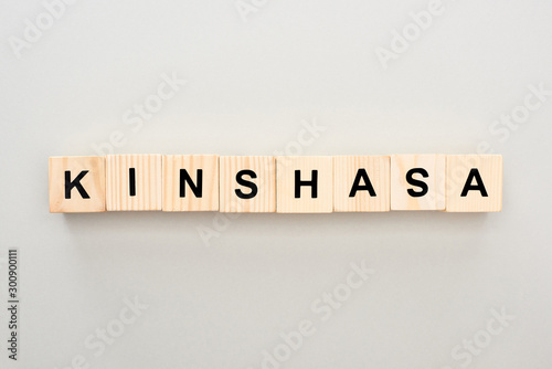 top view of wooden blocks with Kinshasa lettering on grey background
