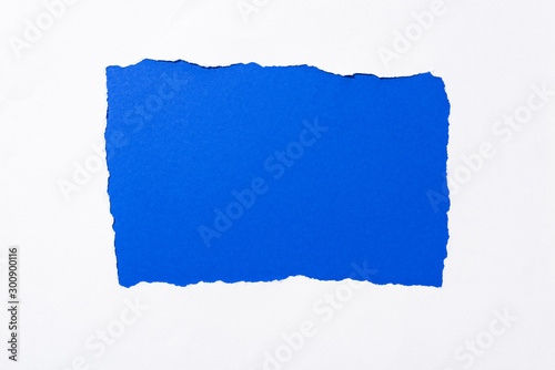 bright electric blue colorful background in white torn paper hole