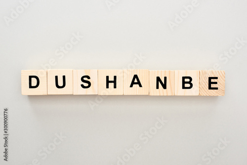 top view of wooden blocks with Dushanbe lettering on grey background